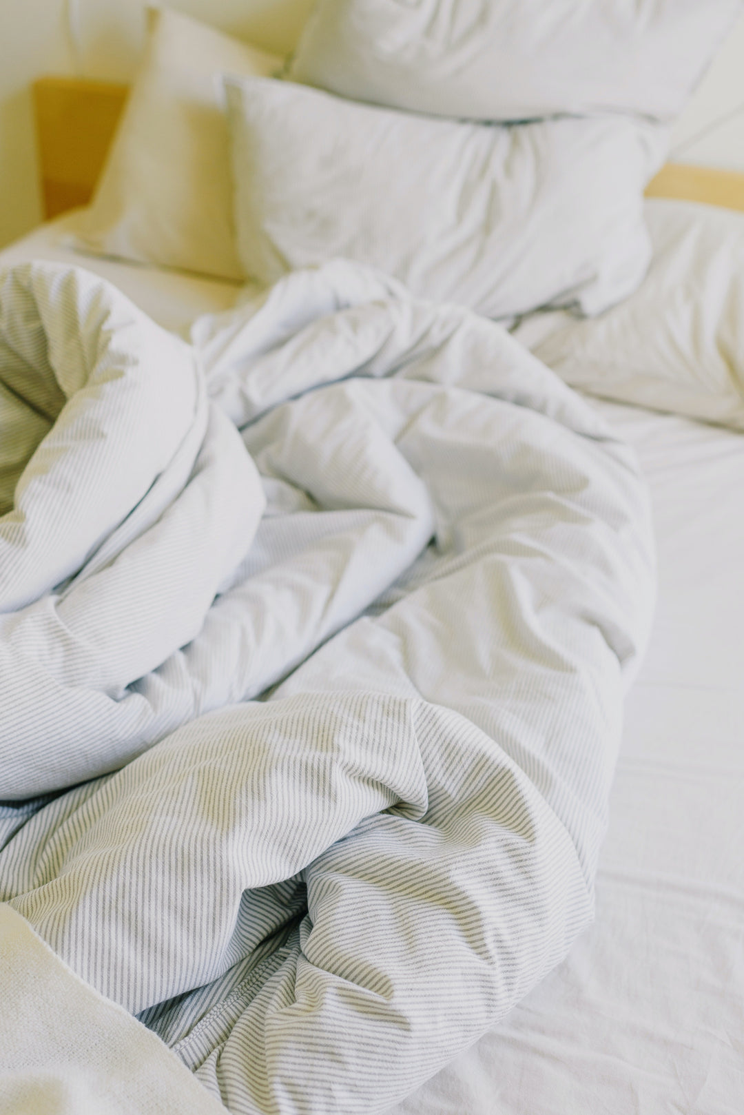 bed with innerspring mattress, blanket, and pillows